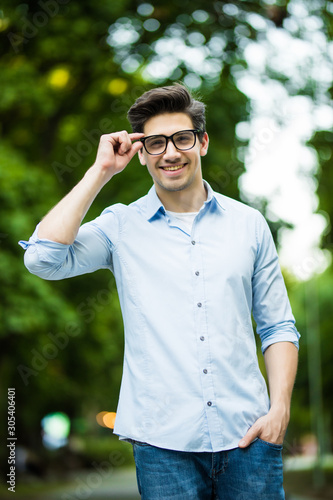 Confident young man in glasses looking at camera