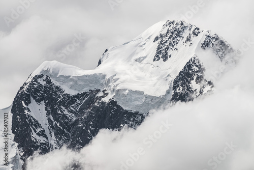 Fotografie Atmospheric minimalist alpine landscape with massive hanging glacier on snowy mountain peak