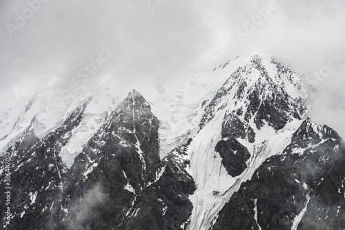 Obraz na plátně Atmospheric minimalist alpine landscape with massive hanging glacier on snowy mountain peak