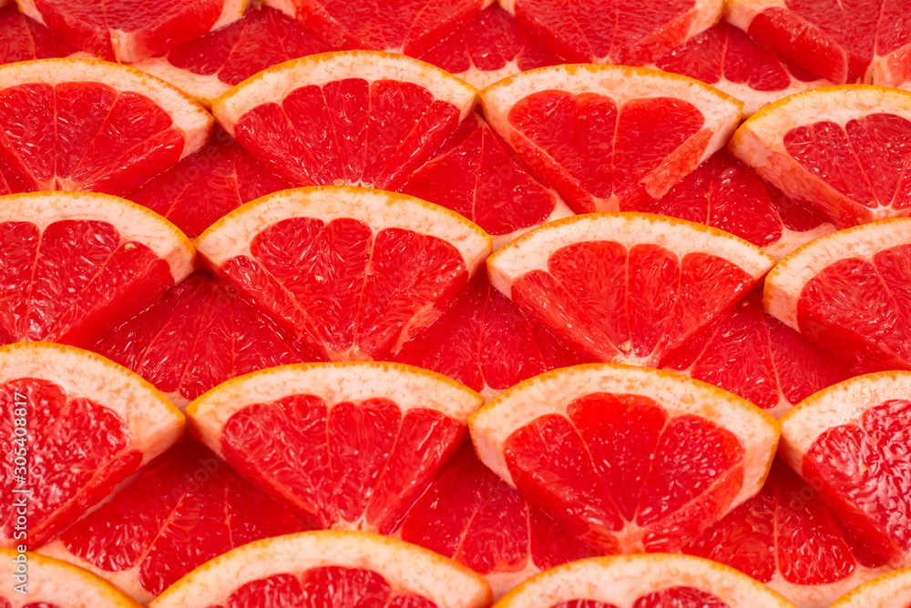 Grapefruit red juicy slices background. top view. Grapefruit red juicy slices background. top view.