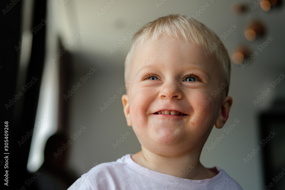 Portrait of a little blond boy with blue eyes