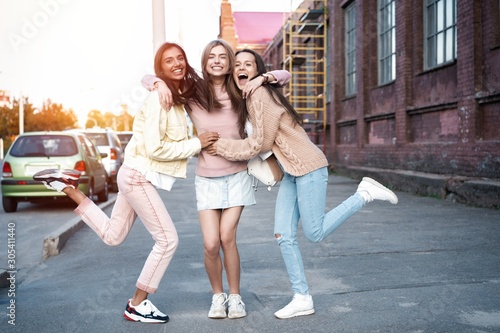 Outdoor shot of three young women having fun on city street
