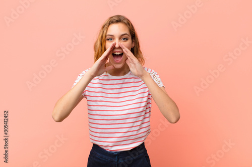 Tableau sur toile young blonde woman feeling happy, excited and positive, giving a big shout out w