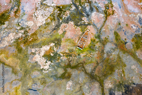 Aerial view of the small boats for salt collecting at pink Lake Retba or Lac Rose in Senegal. Photo made by drone from above. Africa Natural Landscape. photo