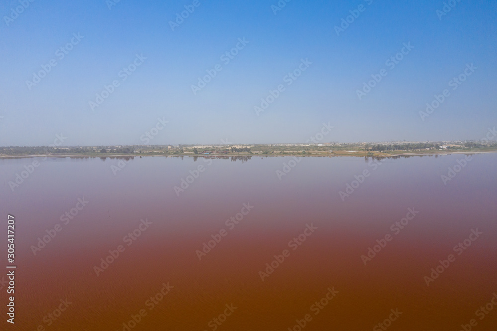 Aerial view of the pink Lake Retba or Lac Rose in Senegal. Photo made by drone from above. Africa Natural Landscape.