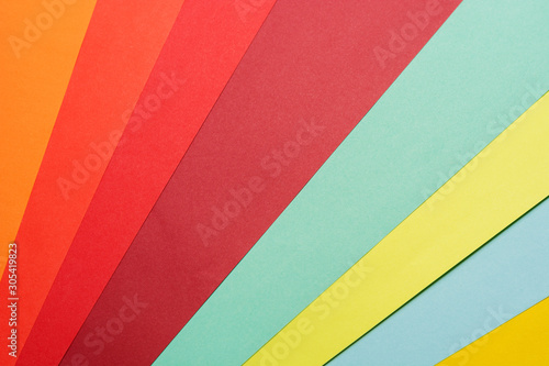 Abstract different pastel colored paper backgrounds with place for text. Diagonal geometric composition. Top view or flat lay.