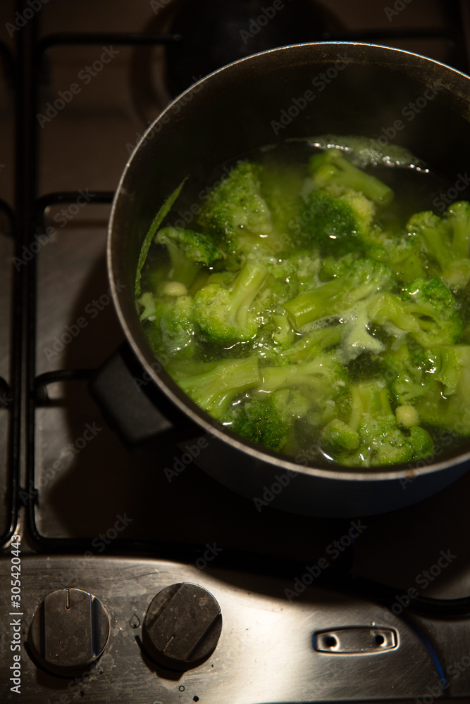 fresh green broccoli cooked boiled in a pan, boiling water fresh green broccoli cooked boiled in a pan, boiling water