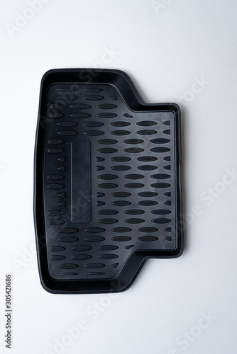 black rear mat for car made of thermoplastic elastomer on a white background photo