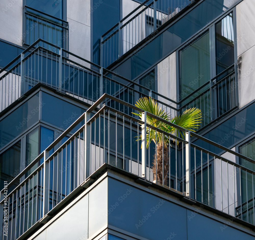 Modern European building. Suburb of Paris, France. Abstract architecture, fragment of modern urban geometry.Balcony greenery exterior europe concept Modern European building. Suburb of Paris, France. Abstract architecture, fragment of modern urban geometry.Balcony greenery exterior europe concept