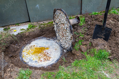 Filled private canalization with stinky wastes. Nature pollution concept.