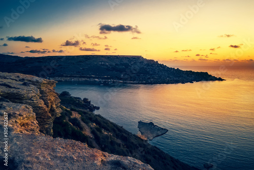 Fototapeta Naklejka Na Ścianę i Meble -  beautiful sunset and seascape view of Golden Bay, Malta, travel background