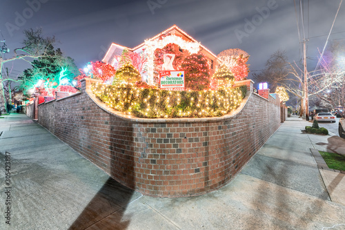 DYKER HEIGHTS, NY - DECEMBER 6, 2018: Christmas lights house decoration display in the suburban Brooklyn neighborhood of Dyker Heights in December photo