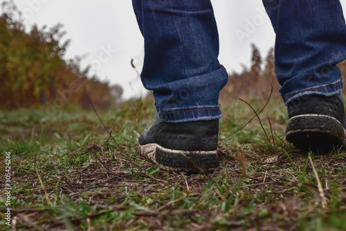 guy in sports shoes on a forest road