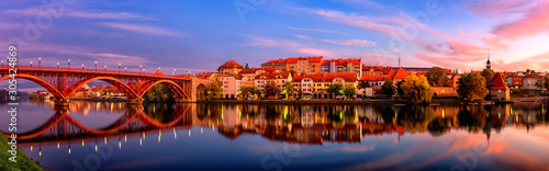 Amazing view of Maribor Old city, Main bridge (Stari most) on the Drava river before sunrise, Slovenia. Scenic cityscape with sky and reflection, travel background for wallpaper or guide book photo
