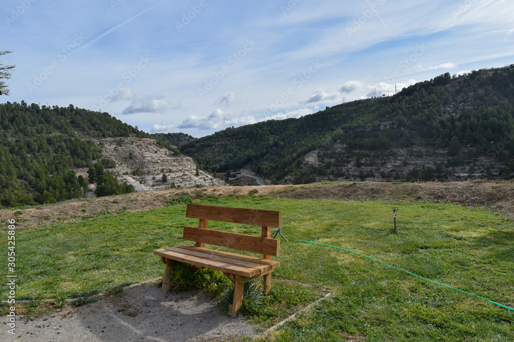 lonely wooden bench on top of a mountain with the sky and other mountains in the background lonely wooden bench on top of a mountain with the sky and other mountains in the background