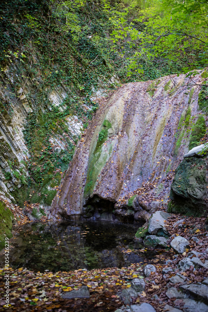 Obraz premium Autumn waterfall in Mamedov gorge in Lazarevsky district of Sochi, Russia. 4 November 2019