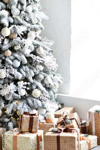 Gifts under the Christmas tree. Christmas background. Christmas tree decorated in white