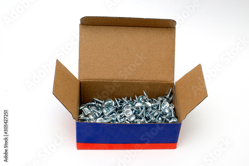 Small pile of Metal galvanized screws. 20 mm screws side view. Fixing materials on a white background. Isolated heap of wood screws