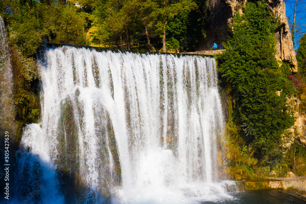 Fototapeta premium waterfall in beautiful nature with crystal clear water on wild river in bosnia and herzegovina at sunny summer day