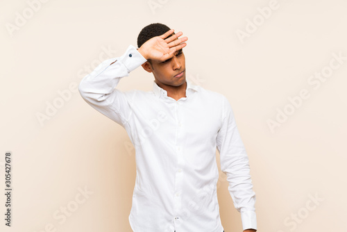 Young handsome brunette man over isolated background with tired and sick expression
