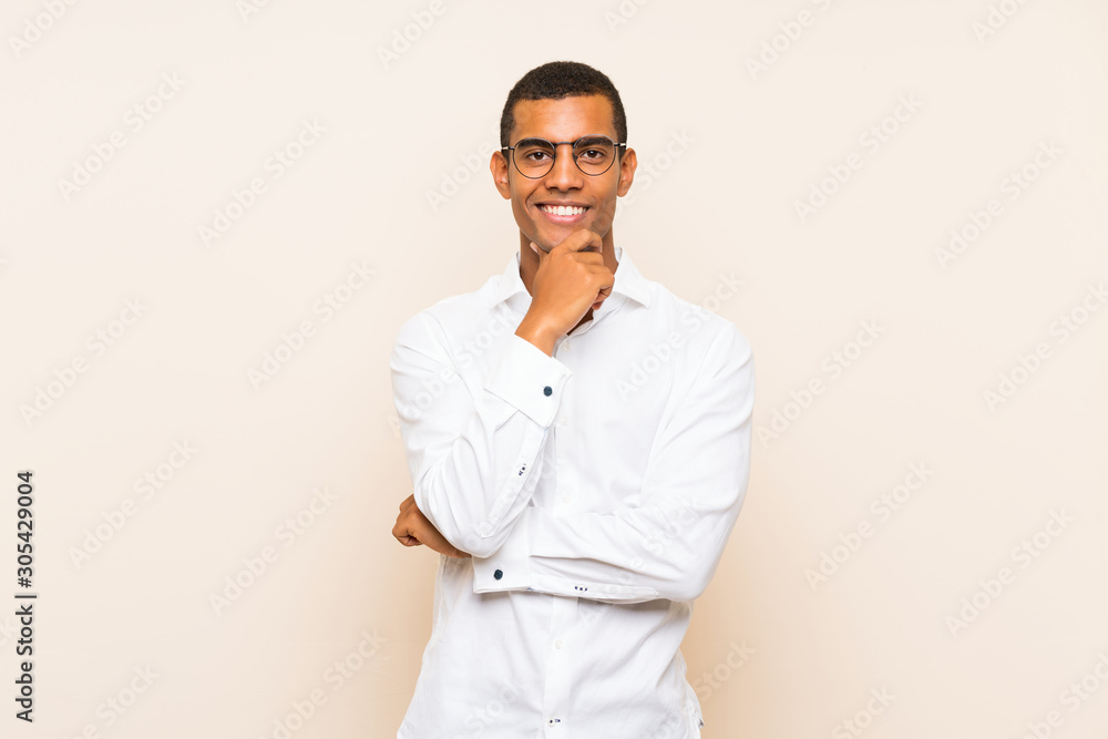 Young handsome brunette man over isolated background with glasses and smiling Young handsome brunette man over isolated background with glasses and smiling