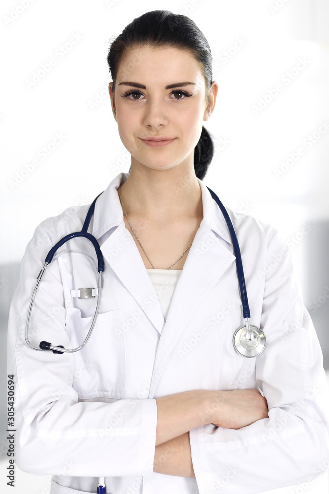 Doctor woman cheerful smiling at camera. Perfect medical service in clinic. Happy future in medicine and healthcare Doctor woman cheerful smiling at camera. Perfect medical service in clinic. Happy future in medicine and healthcare