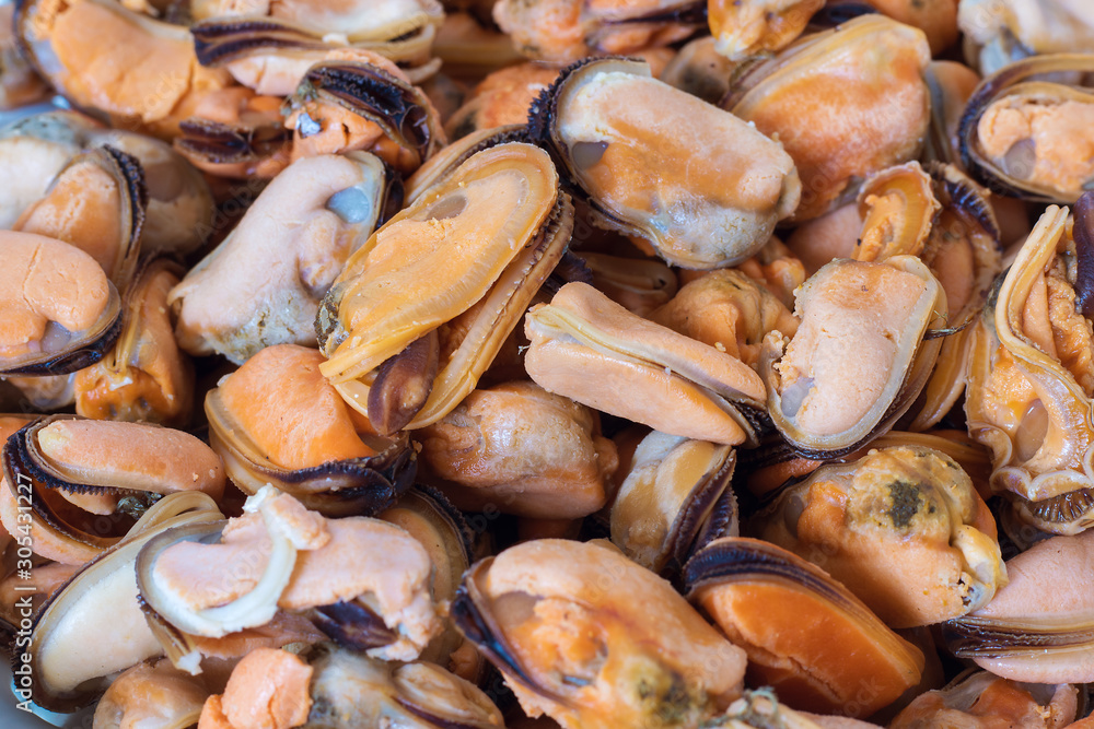 Boiled mussels in a plate on a white background Boiled mussels in a plate on a white background