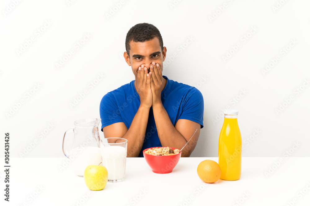 Young man having breakfast in a table with surprise facial expression Young man having breakfast in a table with surprise facial expression