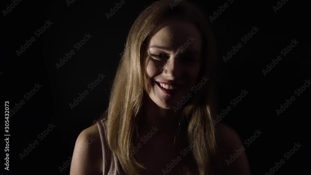 Pretty sexy girl smiling and posing into camera in studio,slowmo Pretty sexy girl smiling and posing into camera in studio,slowmo