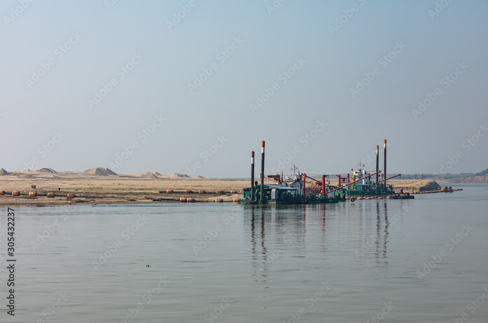 Mandalay, Myanmar - February 15 2019: Extraction of building materials for the construction industry, beside the Irrawaddy river, Myanmar (Burma).