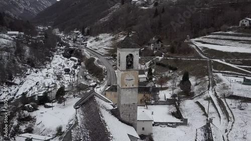 Cinematic aerial view at Lavertezzo, Switzerland in winter season. Lavertezzo is a small village with a valley and mountains along the river Verzasca in the Swiss canton Ticino.