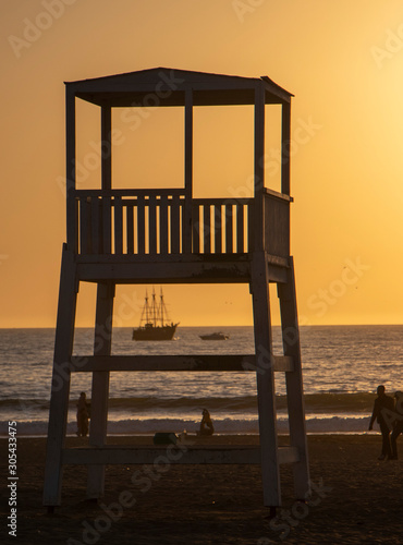 chair on the beach at sunset