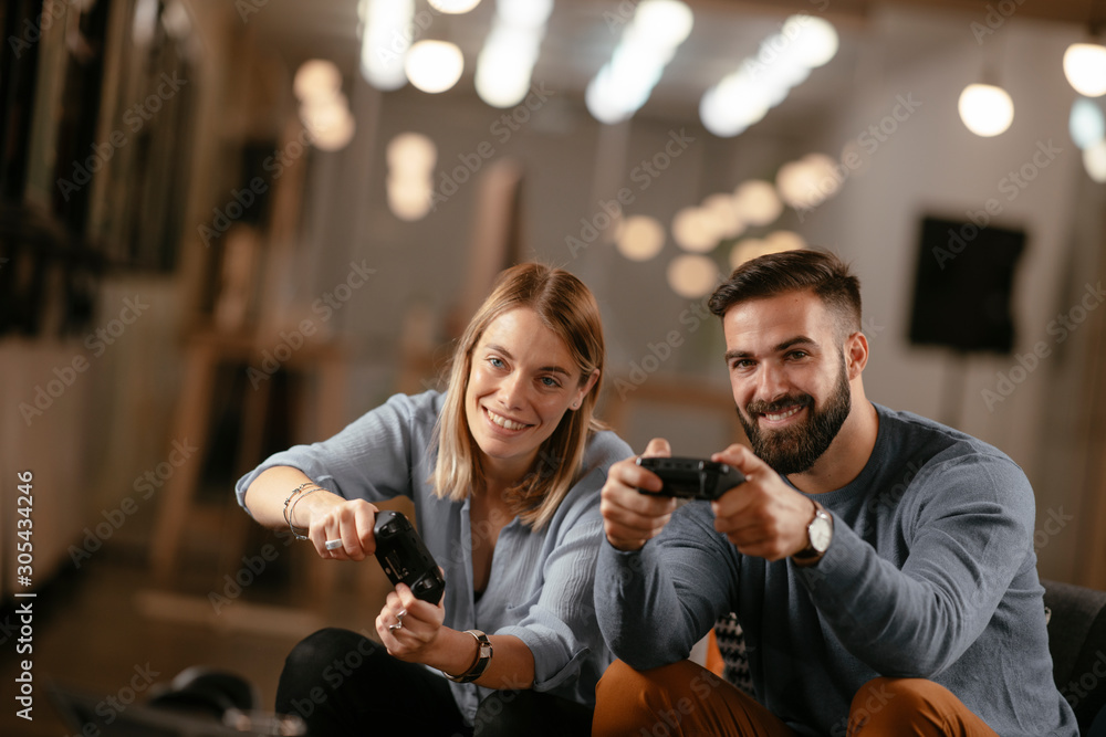 Fototapeta premium Happy young couple. Couple playing video game.