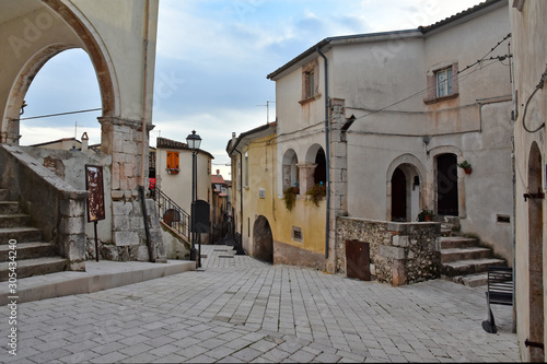 Fototapeta Naklejka Na Ścianę i Meble -  Fornelli, 11/23/2019. A narrow street among the old houses of a mountain village in the Molise region
