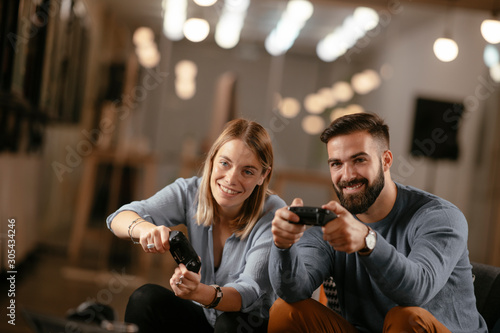 Happy young couple. Couple playing video game. 