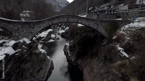 Cinematic aerial view at Lavertezzo, Switzerland in winter season. Lavertezzo is a small village with a valley and mountains along the river Verzasca in the Swiss canton Ticino.