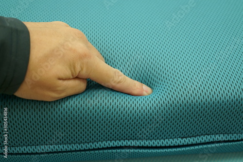 Hand to check the softness of the cushion photo