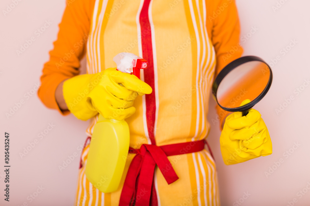 Image of housewife cleaning with spray bottle and magnifying glass. Image of housewife cleaning with spray bottle and magnifying glass.
