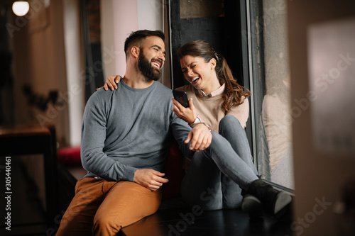 Young happy couple. Partners talking with friends on video call. 