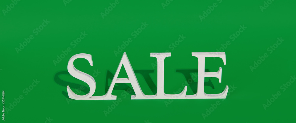 Green Friday concept. Wooden symbol word with text Sale on green backround. Shopping concept Green Friday concept. Wooden symbol word with text Sale on green backround. Shopping concept