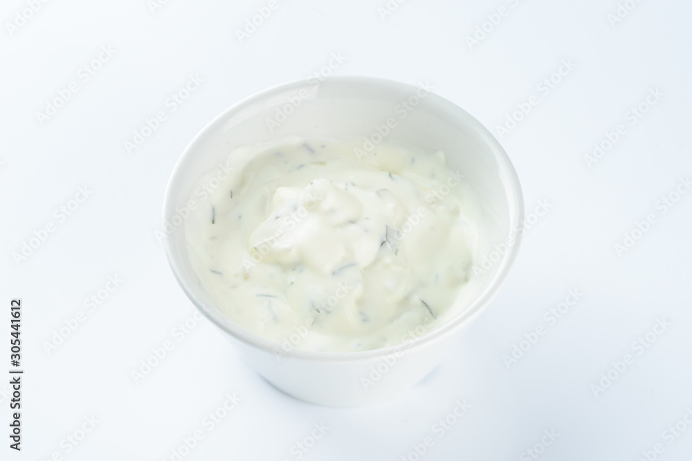 cream sauce with pickles in a bowl on a light background, mayonnaise cream sauce with pickles in a bowl on a light background, mayonnaise