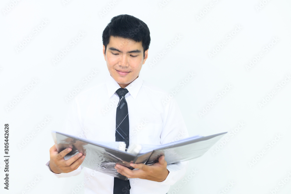 Young Asian businessman inspecting his document. Young Asian businessman inspecting his document.