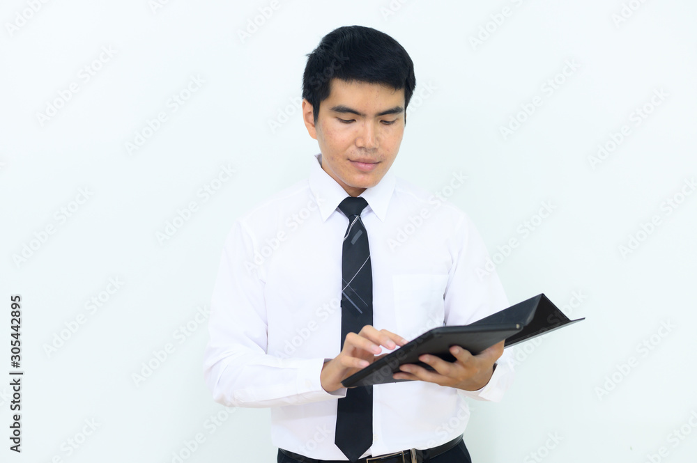 Young Asian businessman pointing at his tablet. Young Asian businessman pointing at his tablet.