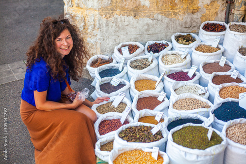 Woman sitting next to bags of spice