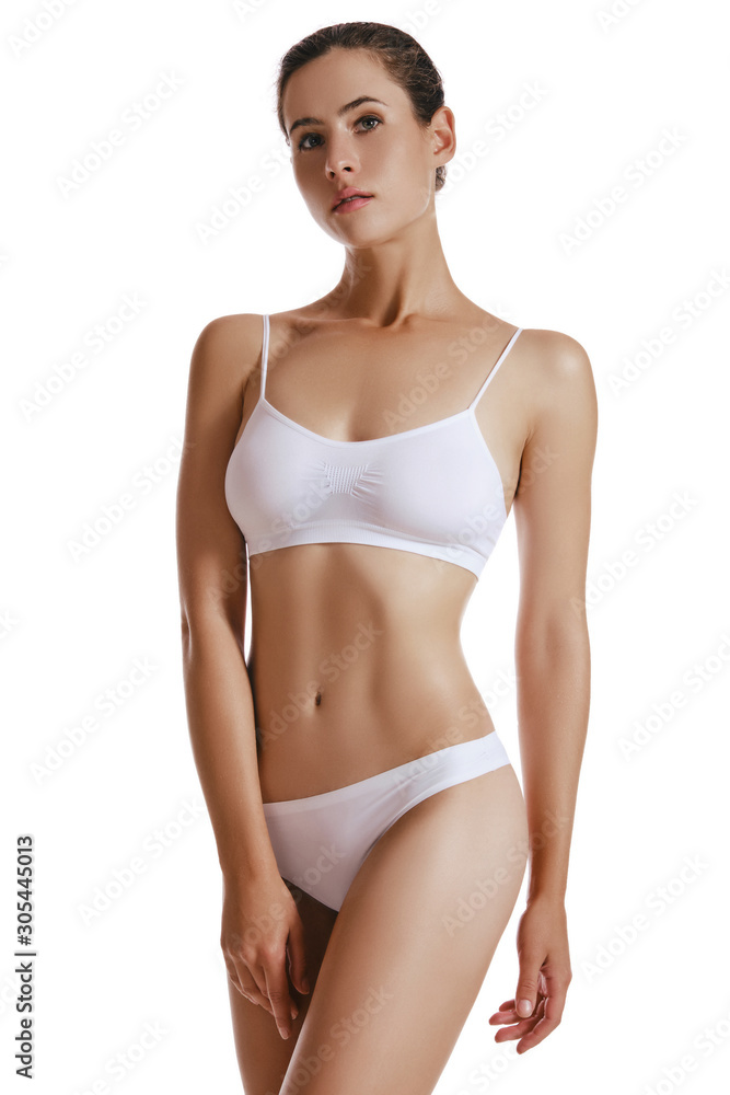 Young woman in white underwear, with bundled hair, posing in studio, isolated on white. Plastic surgery, aesthetic cosmetology. Close-up. Young woman in white underwear, with bundled hair, posing in studio, isolated on white. Plastic surgery, aesthetic cosmetology. Close-up.