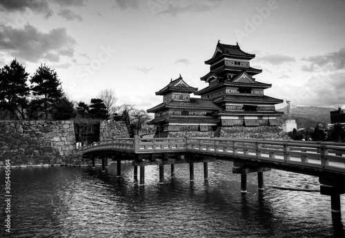 Matsumoto Castle (Matsumoto-jo) Japan's main historic castle | Black and White Version | Japanese red wooden bridge. Japan's famous historic castle in Nagano Prefecture | Famous tourist attraction H