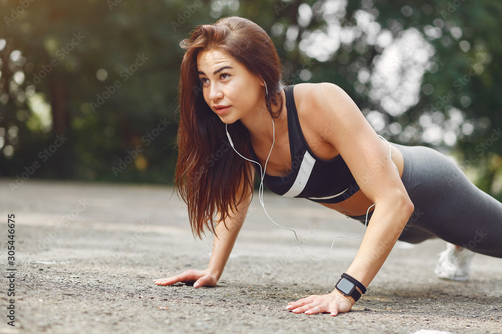 Beautiful girl training. Sports girl in a sportswear. Brunette with headphones Beautiful girl training. Sports girl in a sportswear. Brunette with headphones
