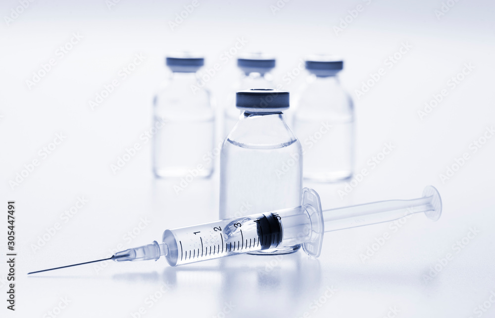 Glass medicine vials and Syringe on white background Glass medicine vials and Syringe on white background