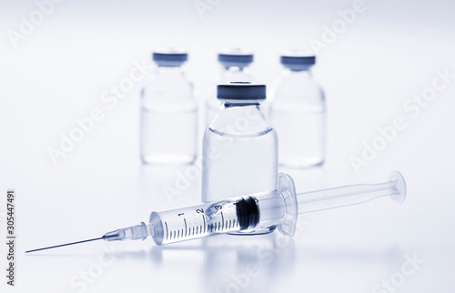 Glass medicine vials and Syringe on white background