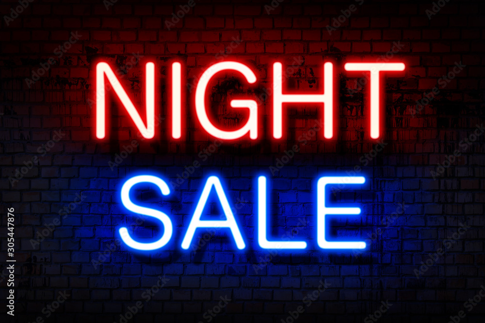 Night sale. Neon sign with luminous letters of red and blue on a black brick wall